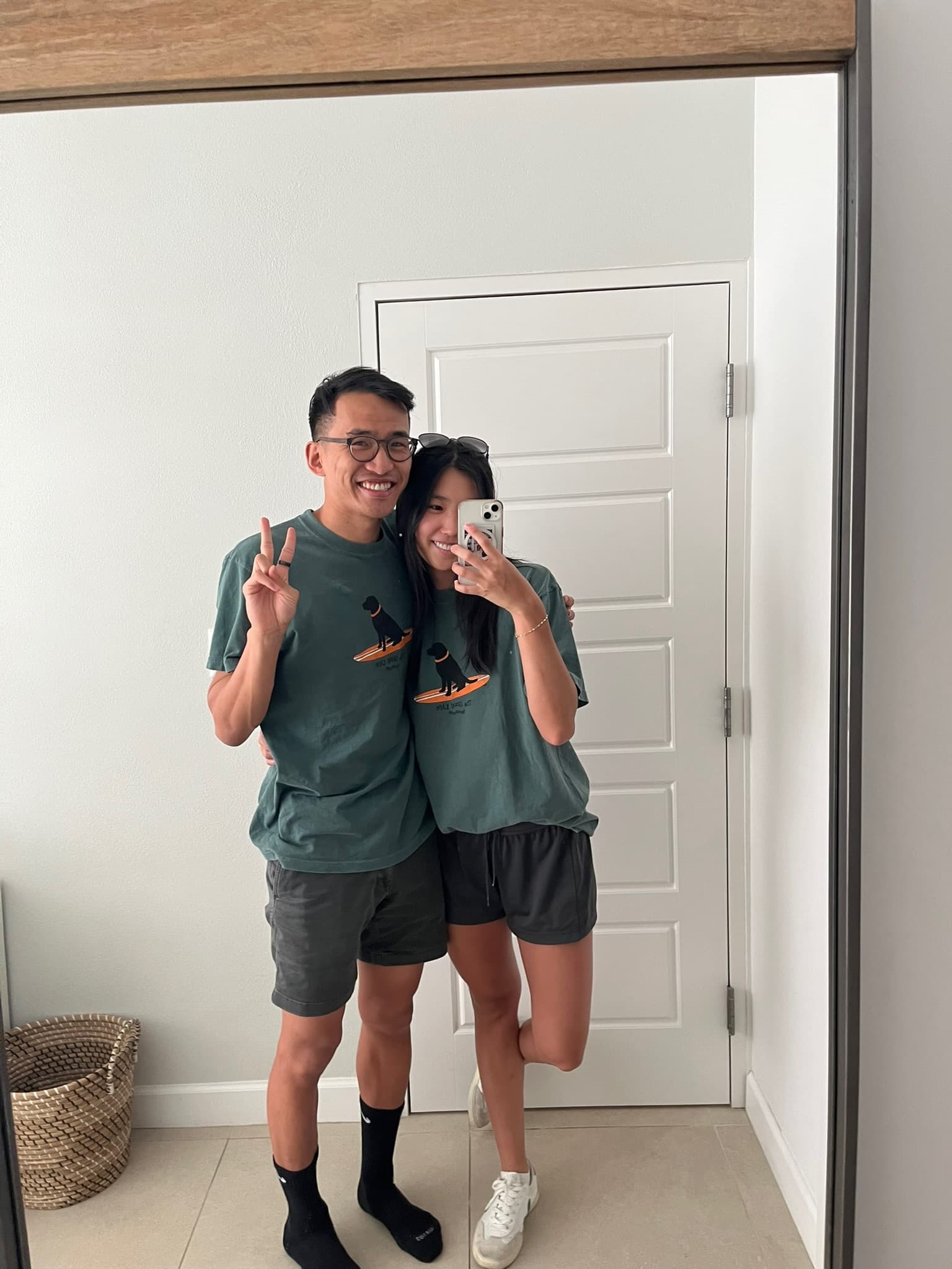 A mirror selfie in matching green T-shirts.