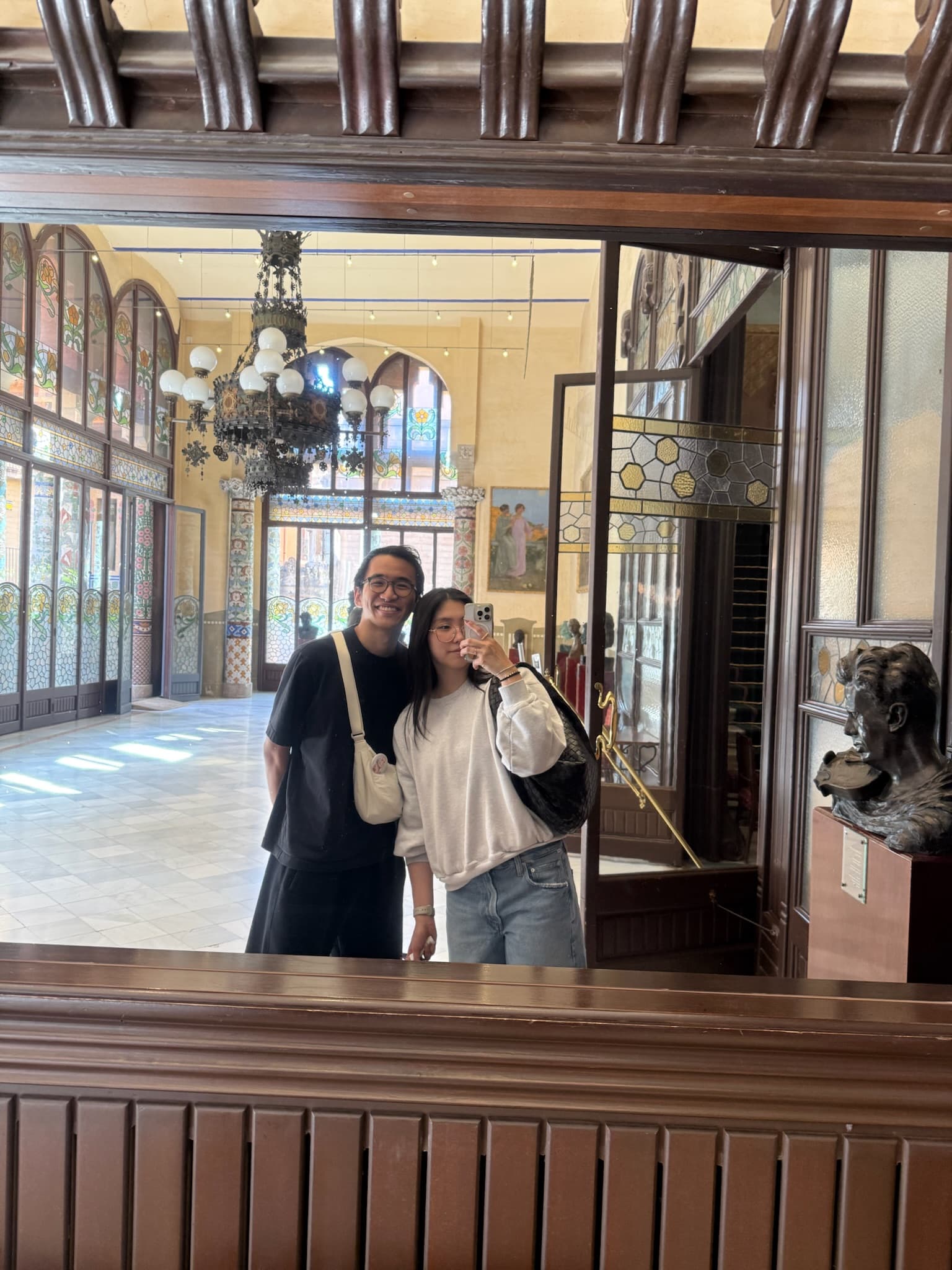 Framed in a wooden window, inside a hall of stained glass and tilework.