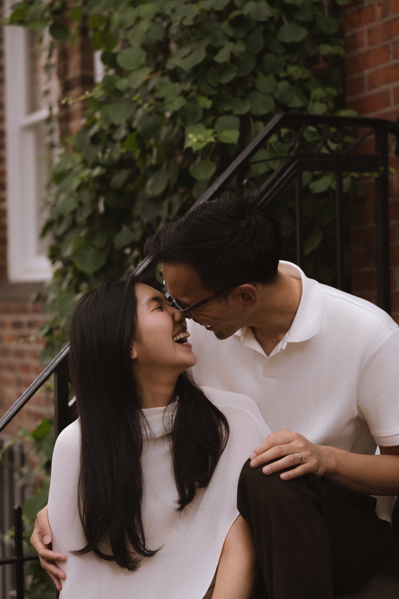 Laughing forehead to forehead on a stoop, ivy climbing the wall behind us.