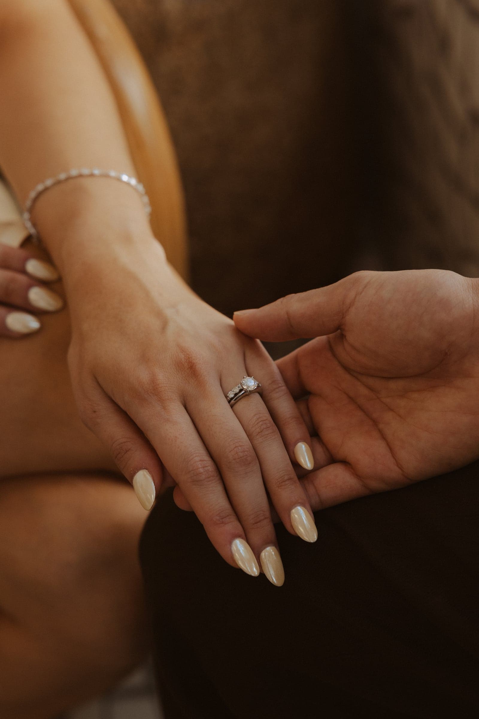 Our hands resting together, the engagement ring on show.