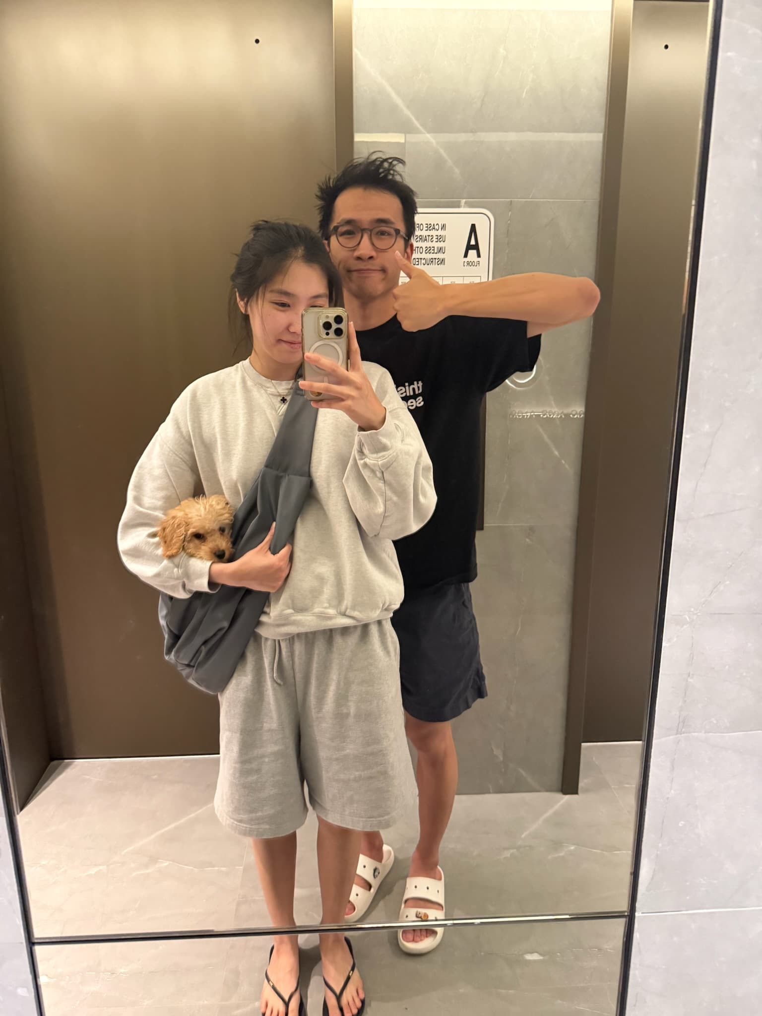 An elevator mirror selfie, with our rabbit riding along in a shoulder bag.