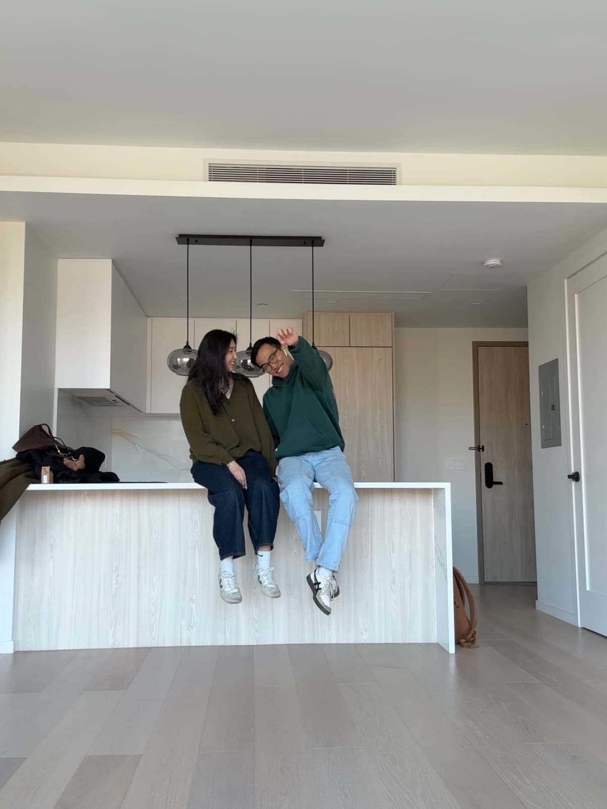 Sitting together on the kitchen counter of an empty apartment.